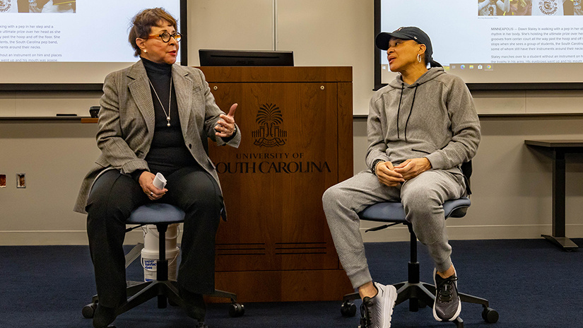 Sheila Johnson speaks with Gamecock women's basketball coach Dawn Staley during a class.