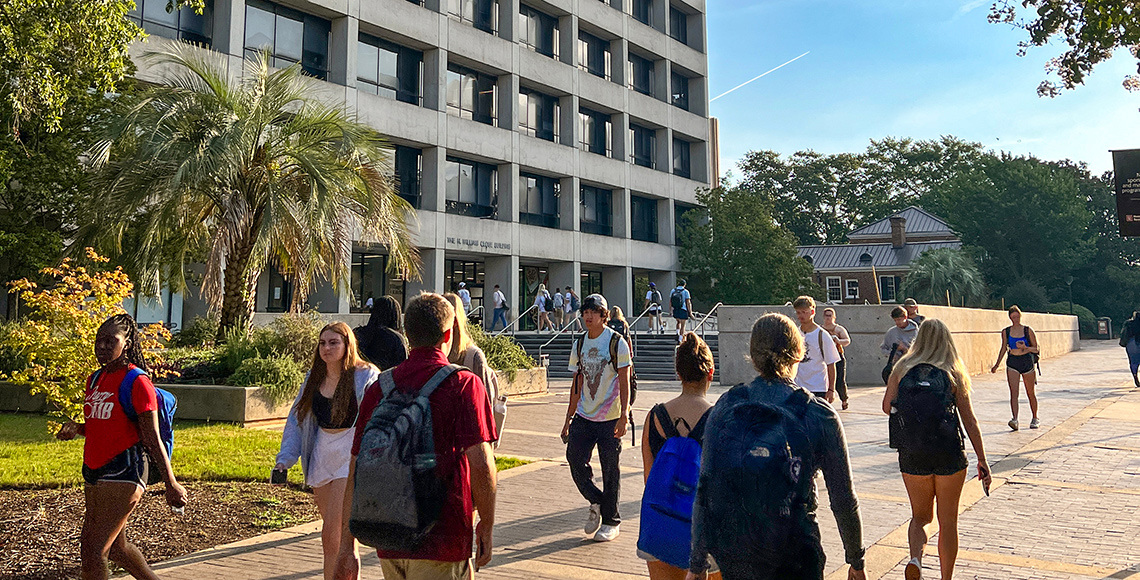 Students walk in front of the Close-Hipp Building.