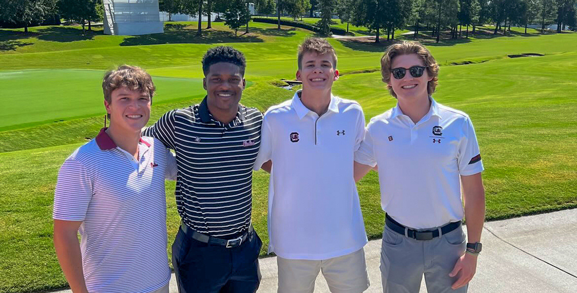 Four students pose for a photo at Quail Hollow in Charlotte, North Carolina.