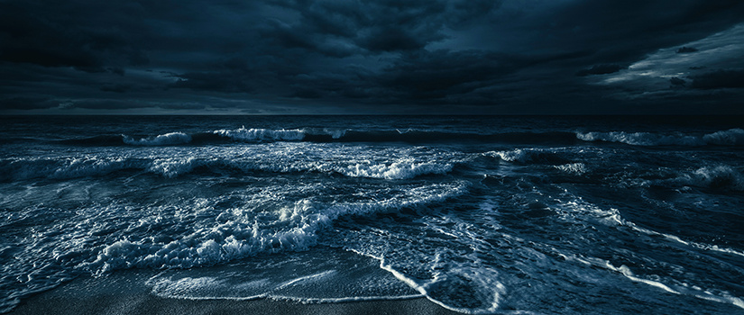 A dark, stormy beach scene.