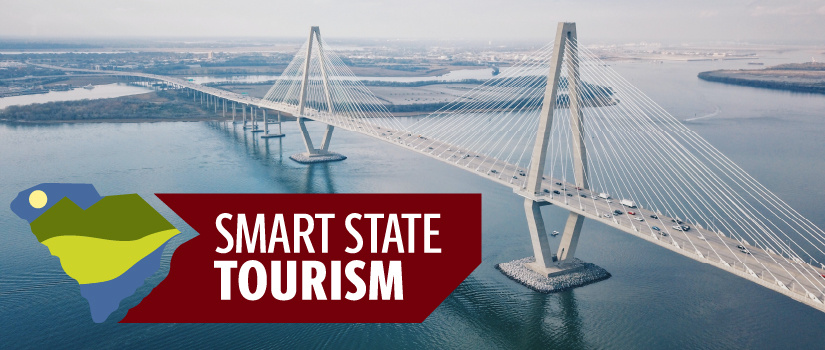 SmartState Tourism graphic overlayed on a aerial shot of a bridge.