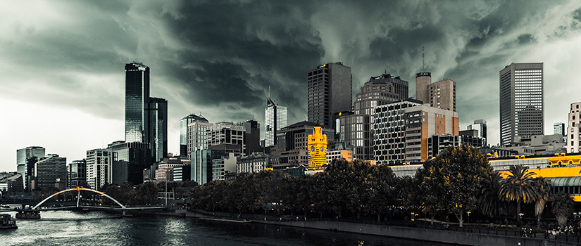 A city skyline with storm clouds above.