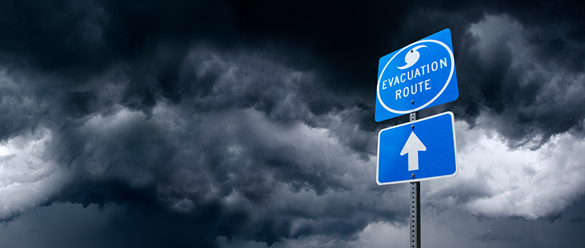 A stormy sky with an evacuation sign to the left