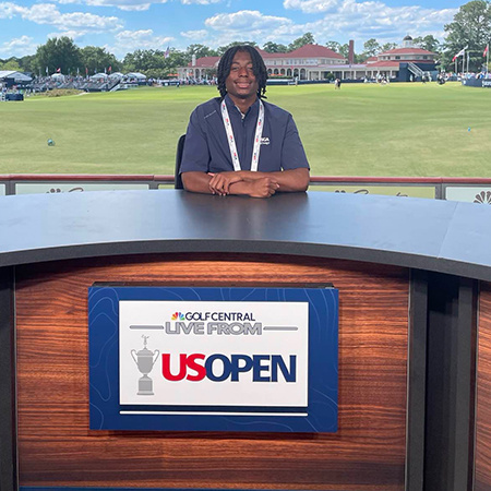 Mekhi Gibson sitting at the NBC Sports TV desk for the US Open