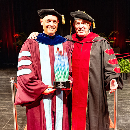 Tim Leiweke receives the inaugural Tim Leiweke Visionary Innovation & Leadership Award from Dean Michael Sagas during the Degrees of Excellence ceremony at the University of South Carolina.