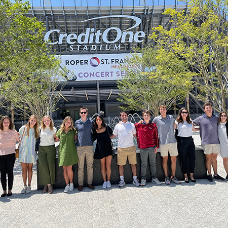 A group of students pose in front of Credit One Stadium in Charleston, South Carolina.