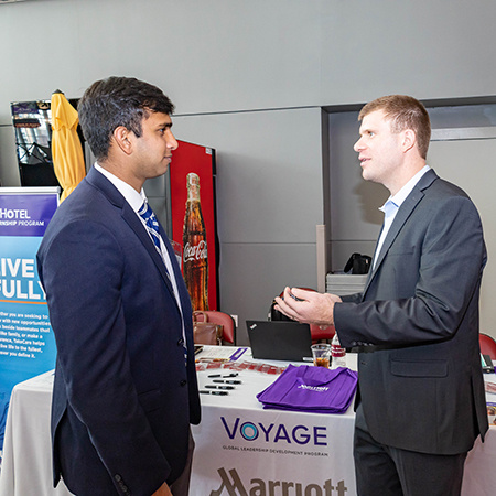 A company representative speaks to a student at Experience Expo.