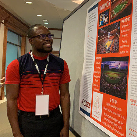 Ph.D. student Kemardo Tyrell looks at a research presentation at CSRI 2022.