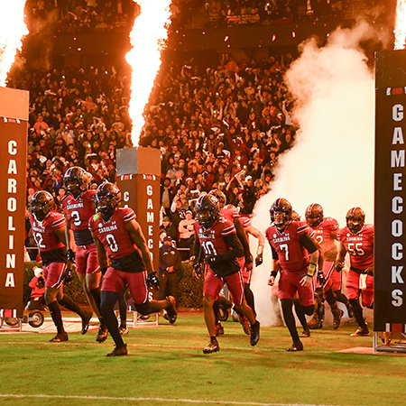 The Gamecock football team takes the field at Williams-Brice Stadium with pyrotechnic effects just outside the tunnel.