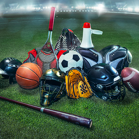A collection of sports equipment on a field with stadium lighting