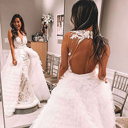 Michelle Doan spent her summer interning at Kleinfeld Bridal. Here she looks into a floor length mirror while wearing a Kleinfeld original wedding gown.