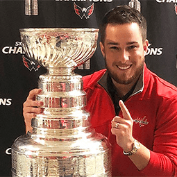 Glen Ivol stands with the NHL trophy after the Washington Capitals are crowned champs
