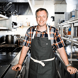 William Dissen poses in his commercial kitchen at The MarketPlace Restaurant