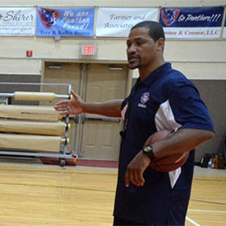 Antonio Grant in the gym coaching a basketball practice