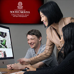 Faculty member Jiyeon Kim demonstrates to students how to use innovative applications to build e-commerce websites.