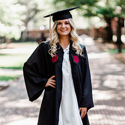 Emily Ruble poses in her cap and gown on UofSC's Historic Horseshoe.