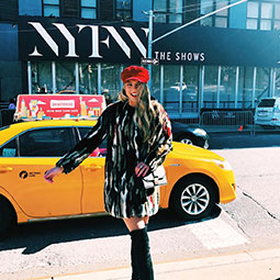 Students steps out of a yellow taxi in high fashion.