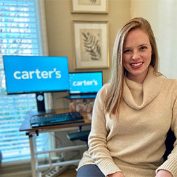 Caroline Riffel sits in her office with the Carter logo prominently displayed on her computer.