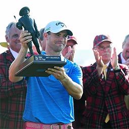 Wesley Bryan raises his trophy after winning the RBC Heritage tournament
