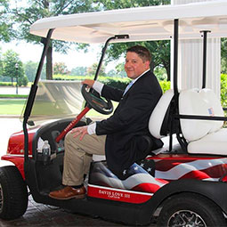 Tom DeLozier rides a golfcart at Quail Hollow Golf Club