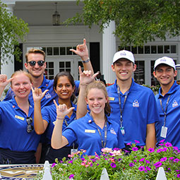 HRTM students give the "spurs up" sign while working at the PGA Champioinship at Quail Hollow Country Club in Charlotte.