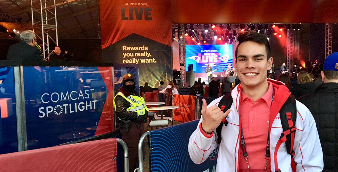 HRSM student Andy Co flashes the spurs up sign while working the Super Bowl Live show in February 2022.