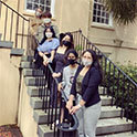 HRSM Global Community Club members masked standing on the steps of the McCutchen House