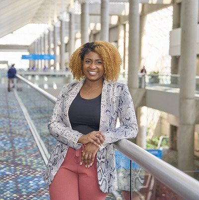 Brittany Martin leans against the railing of the Georgia World Congress Center