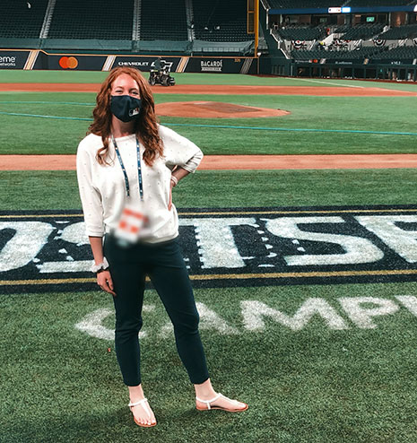 Madison Benner, who works within the MLB bubble system during Covid-19, stands on MLB's Globe Life Field. 