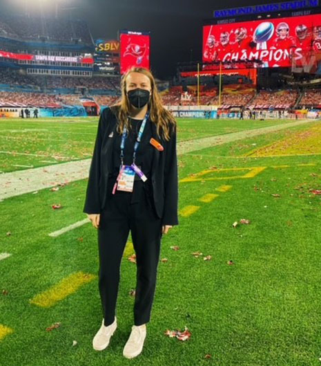 Logan Hudson stands on the field of Raymond James stadium after Super Bowl LV.