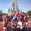 Theme Parks and Attractions Club members at the Magic Kingdom castle on a visit to Disney.