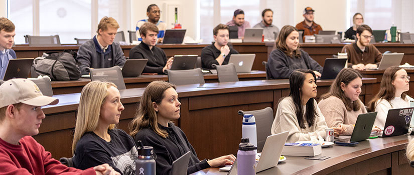 Students in classroom listening to Tax Clinic director