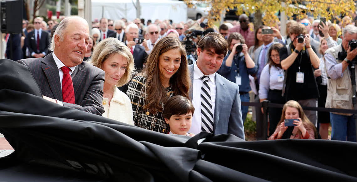 The Rice family standing in front of building during naming ceremony