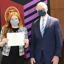 Student with Dean Hubbard after receiving her award certificate