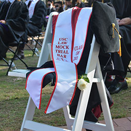 empty chair with graduation cap in memory of jason dunn
