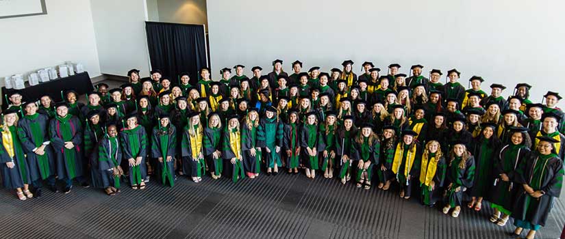 Aerial photo of a large group of medical school students in their academic robes
