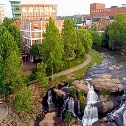 Aerial view of downtown greenville with river and falls.