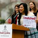 Excited student at podium shows here residency match