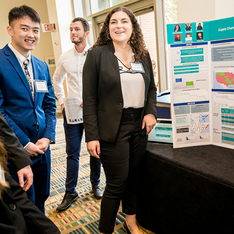Photo of Katherine DeWeese presenting her Siemens project poster at the fall 2019 Industry Summit