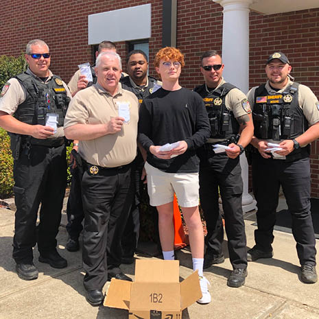 Image of Hart Bridges with officers from the Gaffney Police Department; Bridges donated masks to their department.