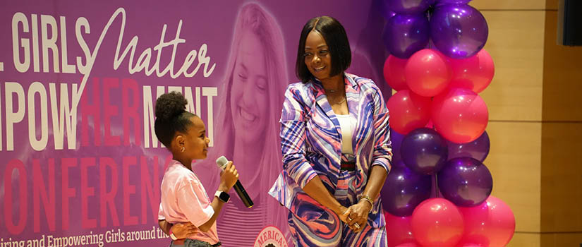 Image of Tragil Wade-Johnson with a girl attendee