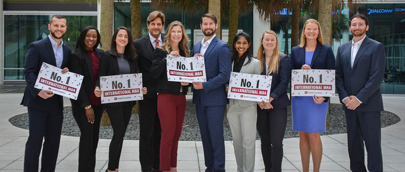 International MBA students holding signs that say No. 1 International MBA.