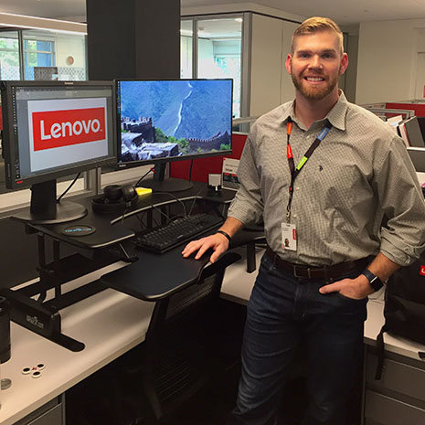 Brennan Dobbins at his desk in Lenovo