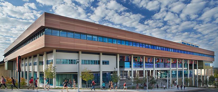 outside photo of moore school building with blue sky background