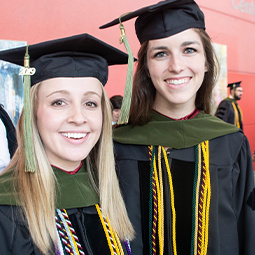 Two students in graduation robes