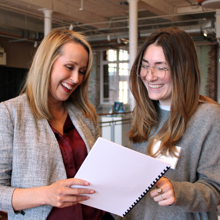 Faculty member and student looking at a report
