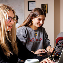 Female students using laptop