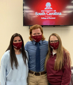 Three students wearing masks