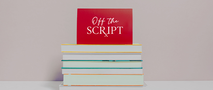 Stack of books with "Off the Script" sign