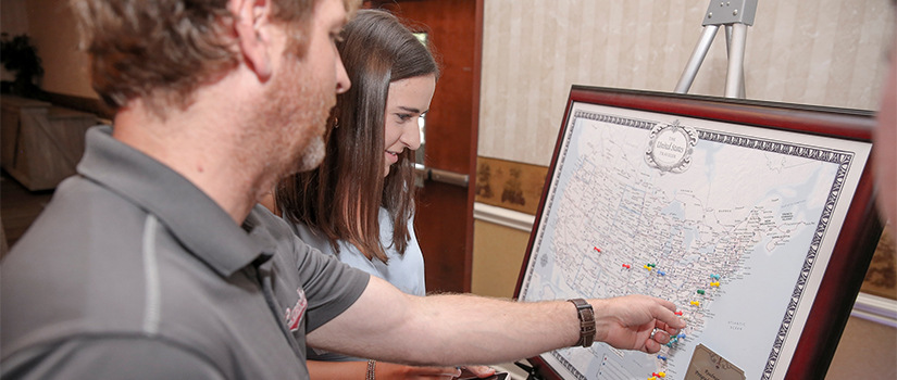 Faculty member and student looking at a map